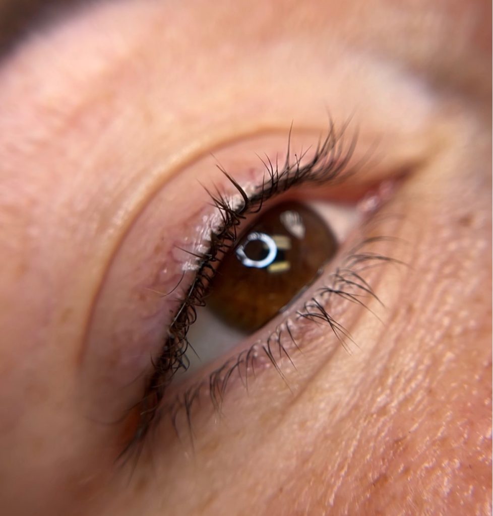 Close-up of Lash Enhancement permanent makeup results.